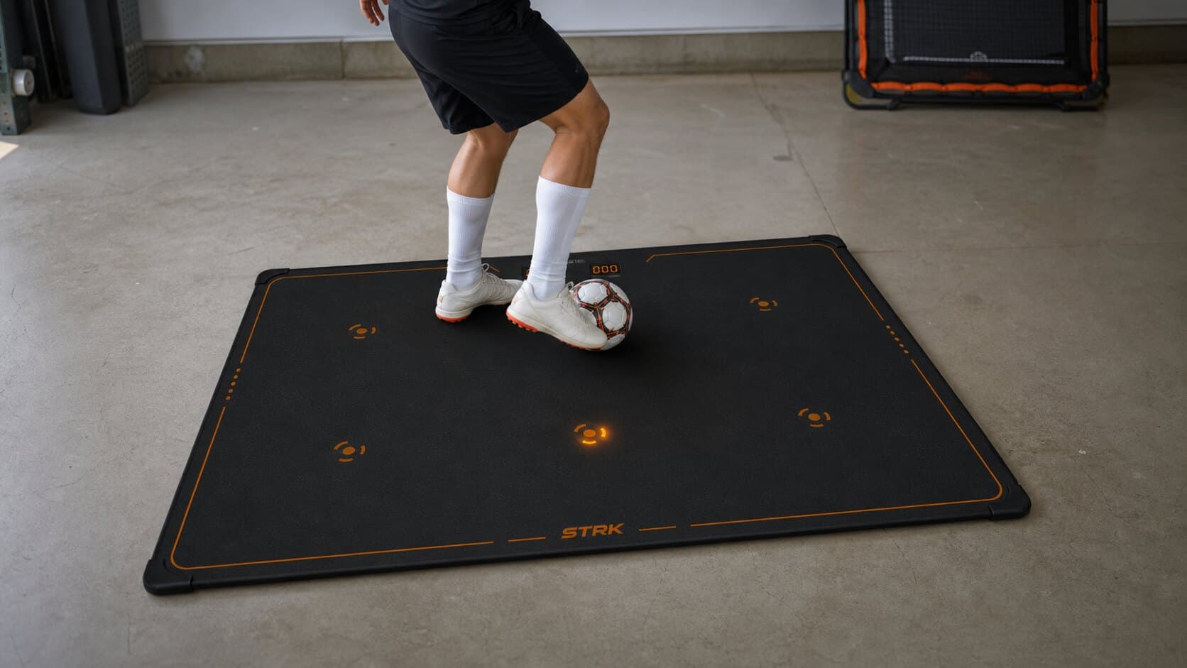 Soccer rebounder alternative for home training with STRK mat