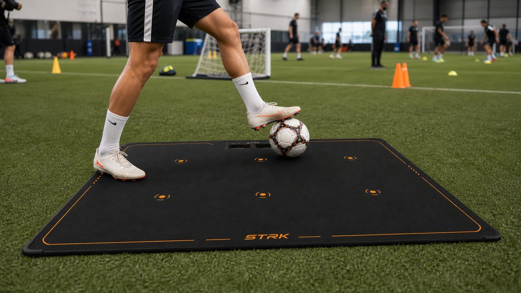 Football academy player using STRK reaction mat in an indoor facility