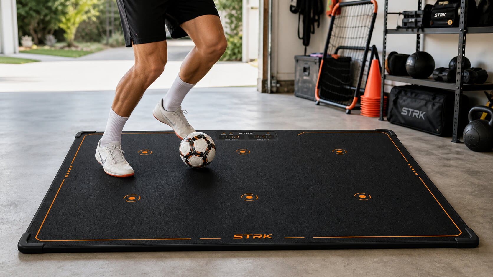 Indoor soccer training setup with the STRK smart mat, ball, and target zones